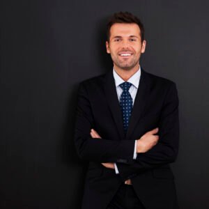 smiling businessman with arms crossed